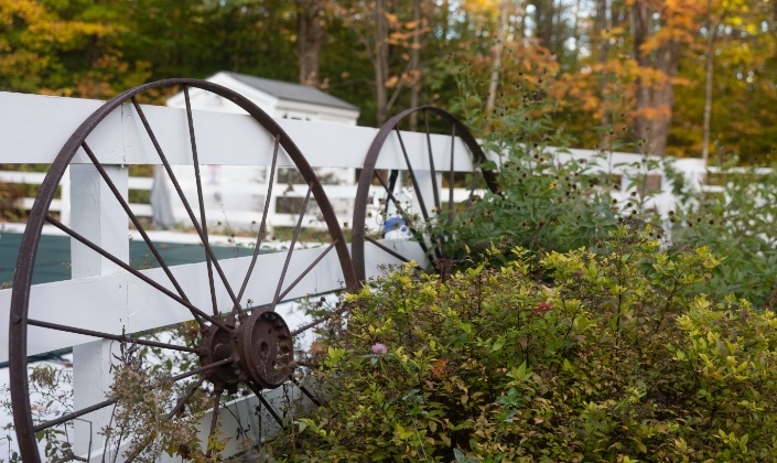 Metal tires leaning against a fence