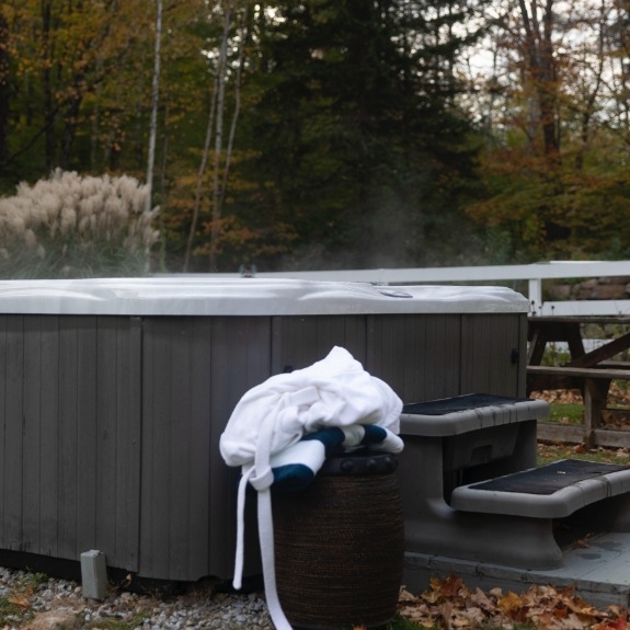 Guest robe on bench next to hot tub