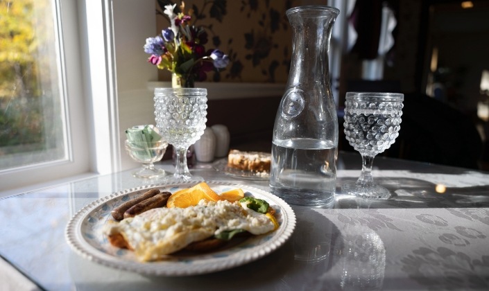 Table set with breakfast and spring water