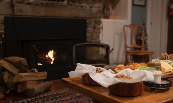 Fireplace next to table set for afternoon snacks