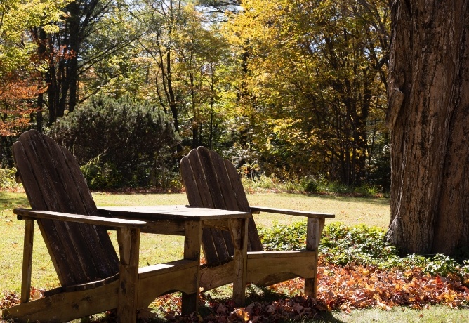 Two adirondak chairs outside Buttonwood Inn on Mt Surprise