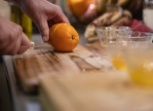 Person slicing oranges