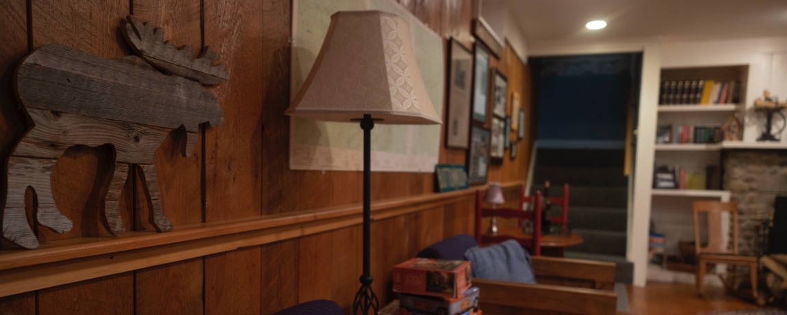 Large meeting room with wood paneling and fireplace