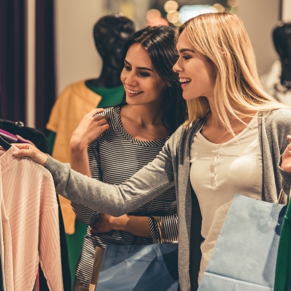 Two women shopping together enjoying the shop and save package