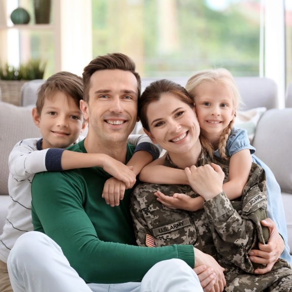 family smiling on couch 