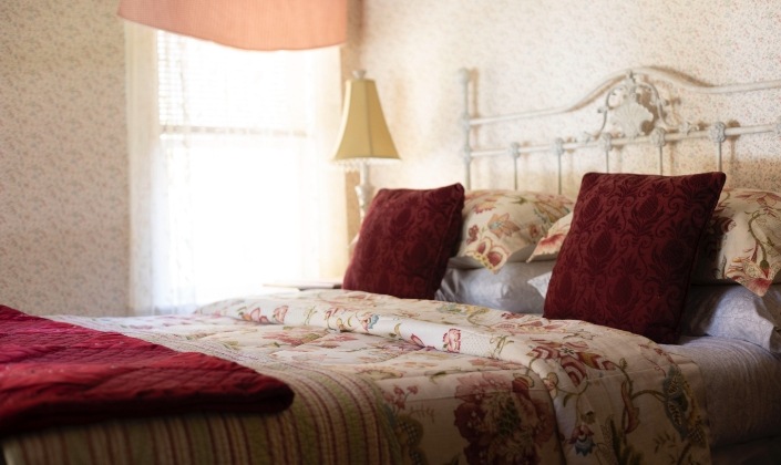 Bed with red flowered quilt