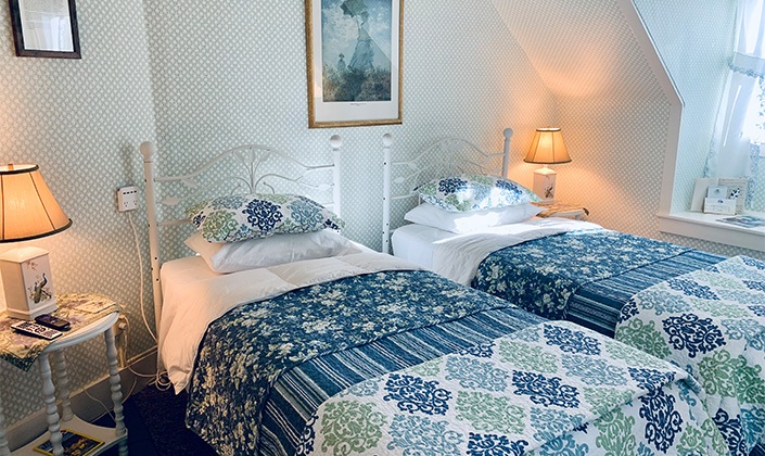 Large bed with blue quilt