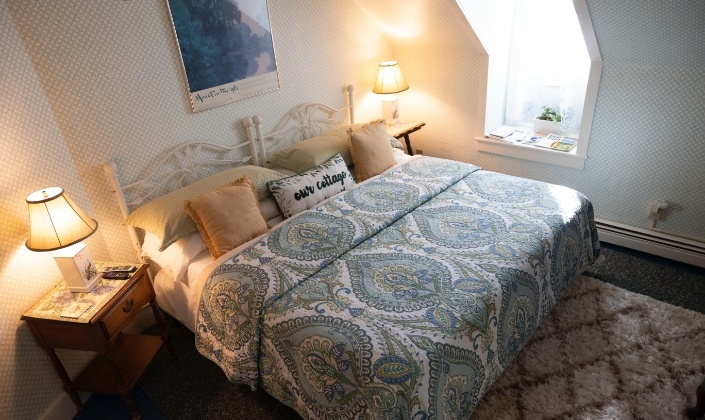 Large bed with blue quilt