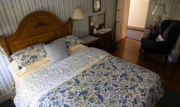 Large bed with blue quilt