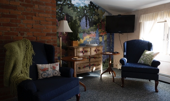 Two chairs and television in seating area