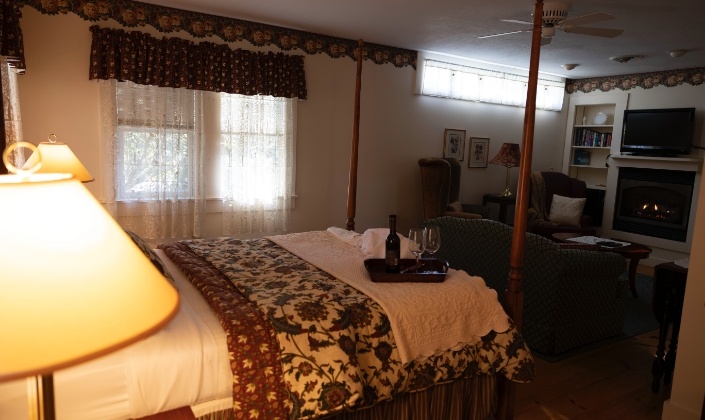 Bed overlooking seating area and fireplace