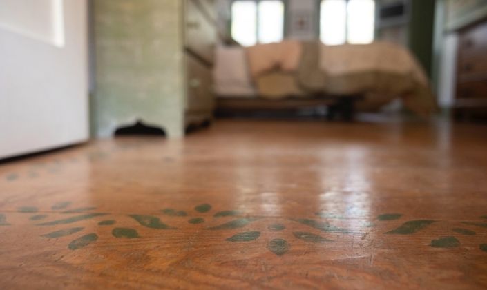 Closeup of hand stenciled guest room floors