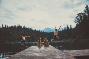 a group of friends swimming in a lake 