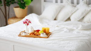 a breakfast platter sitting on a bed